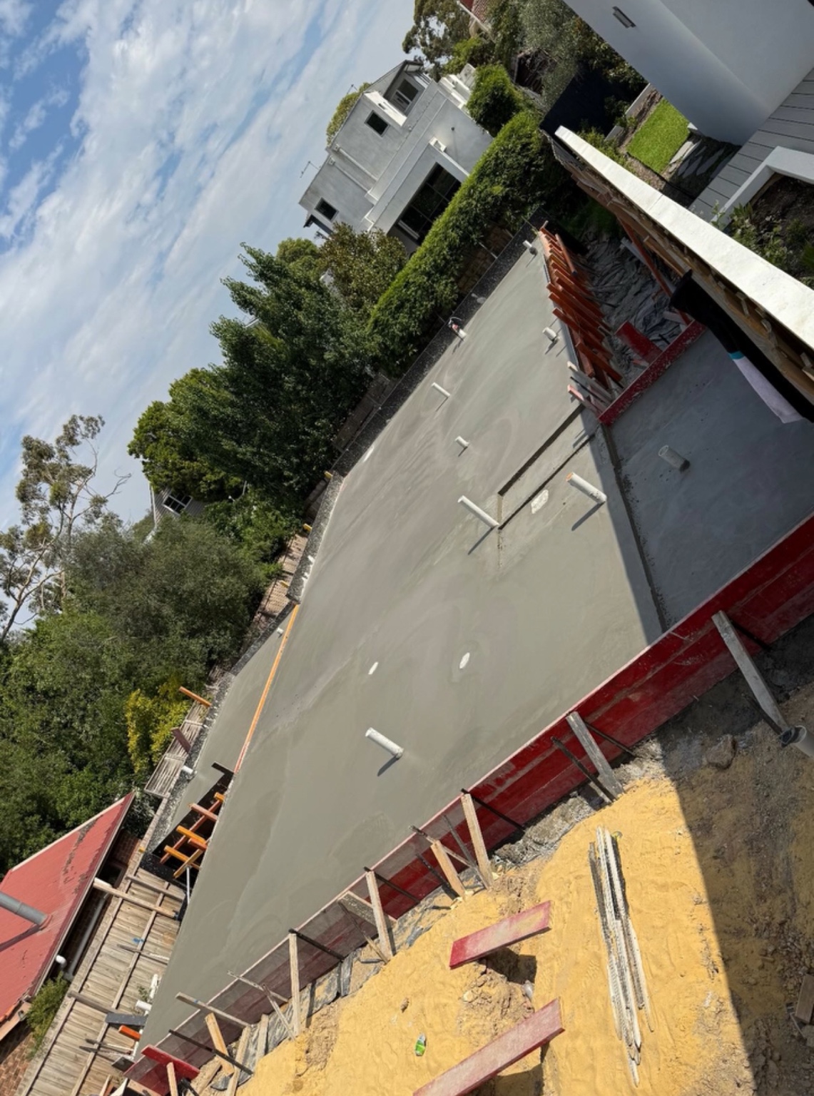 Residential foundation concrete slab with formwork and plumbing penetrations
